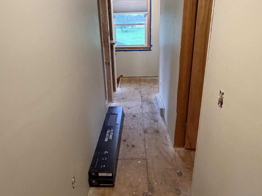 Hallway before new flooring, down to the plywood subfloor