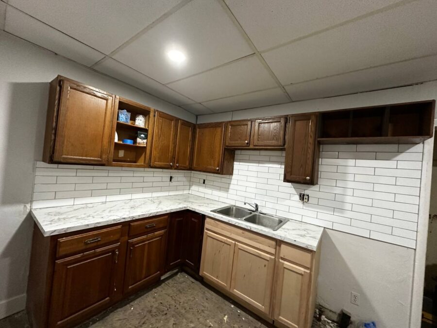 Kitchen with new marble countertops and subway tile backsplash