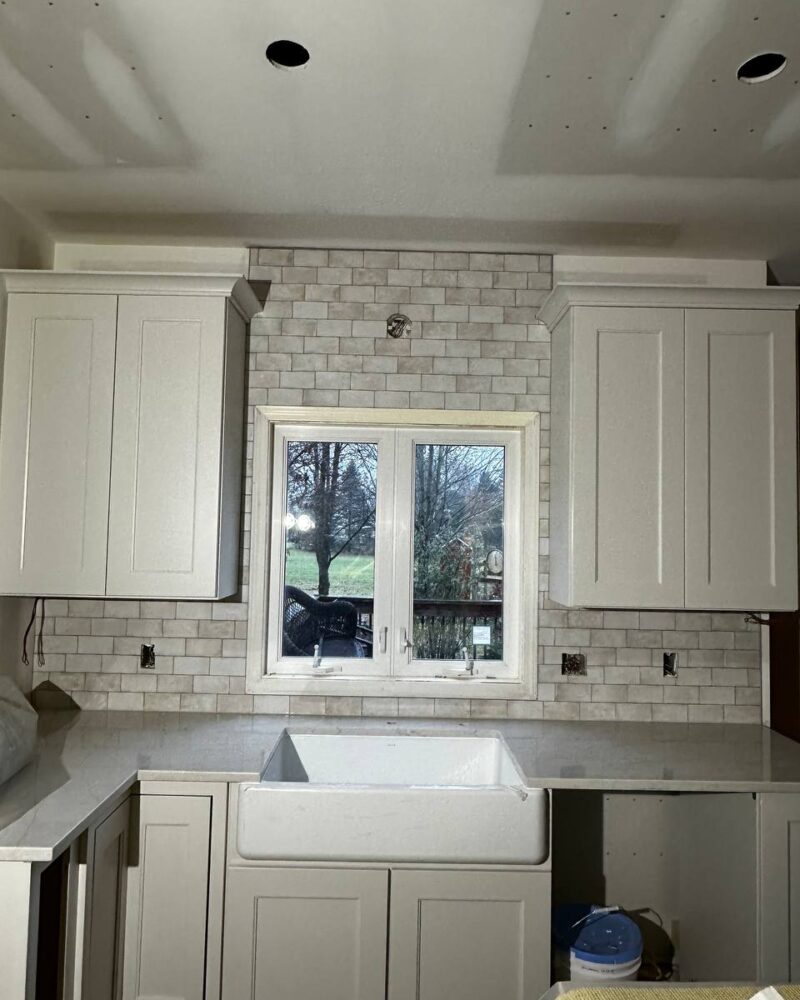 Farmhouse kitchen with white shaker cabinets and apron sink
