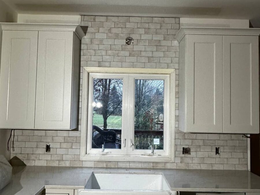 Farmhouse kitchen with white shaker cabinets and apron sink