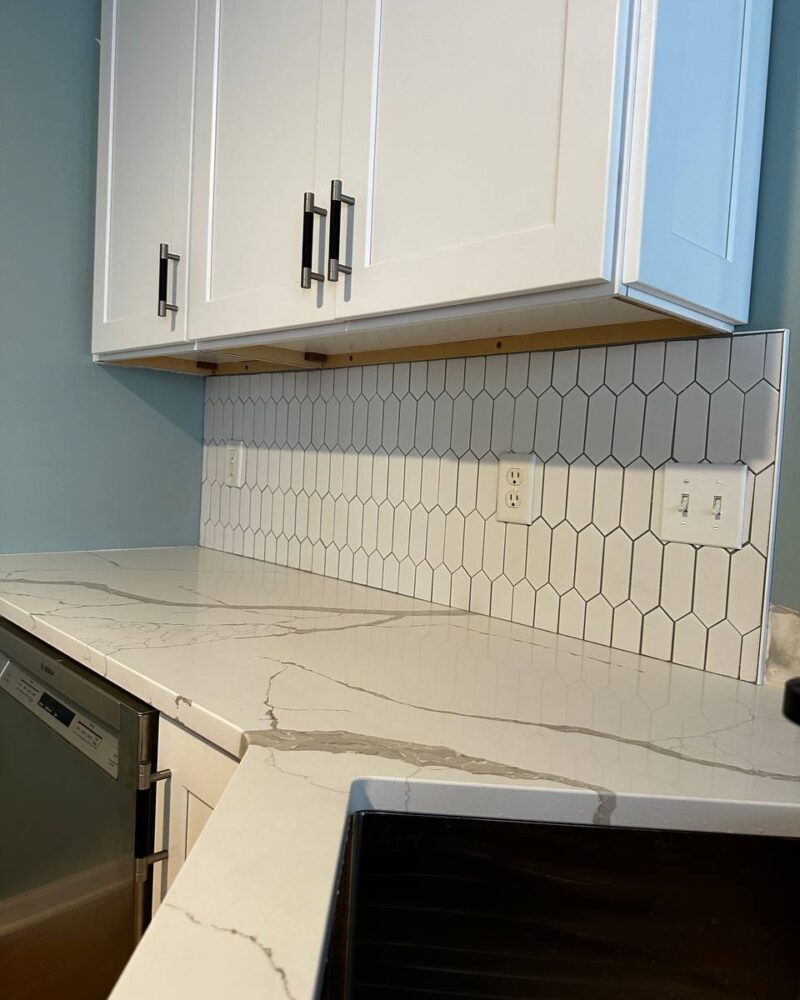 Quartz countertop with hexagon tile backsplash