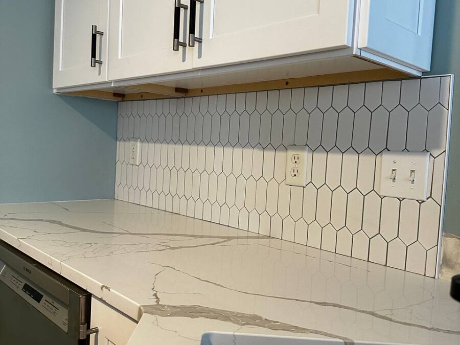 Quartz countertop with hexagon tile backsplash